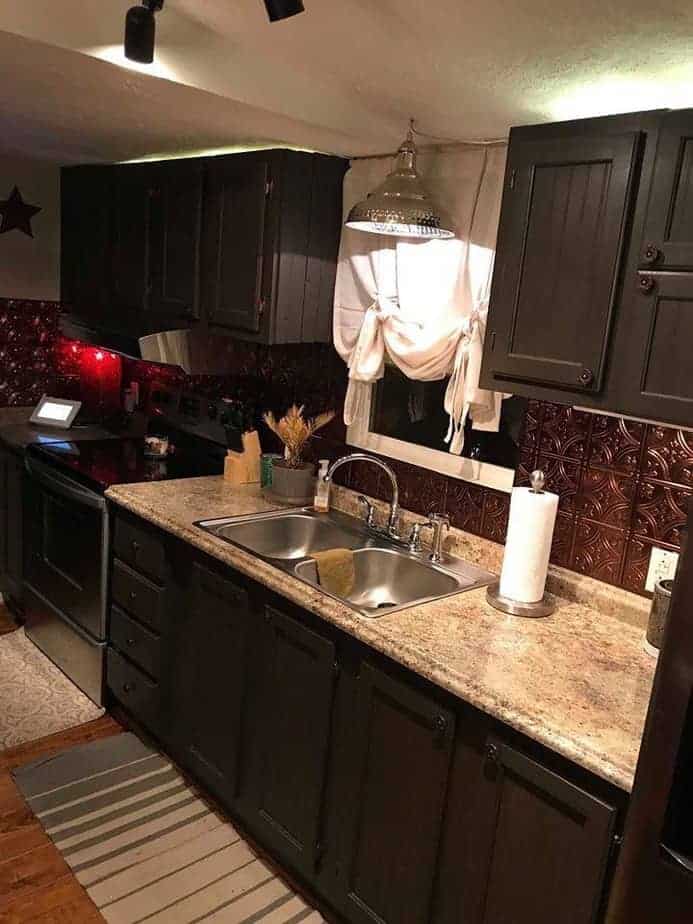 Va mobile home kitchen with laminated granite counters and dark painted cabinets