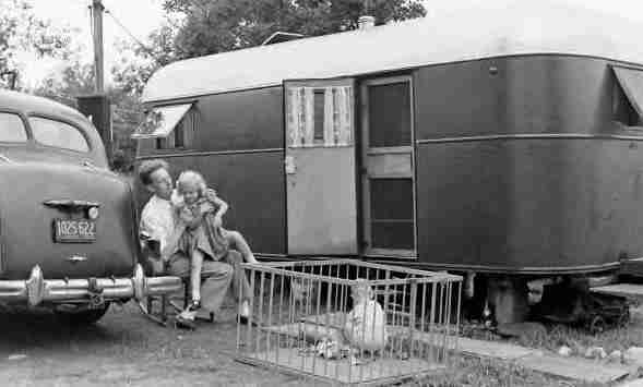 Children and dad in front of 1940 trailer and car