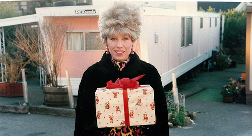 Christmas in a mobile home - lady with gift in mobile home park