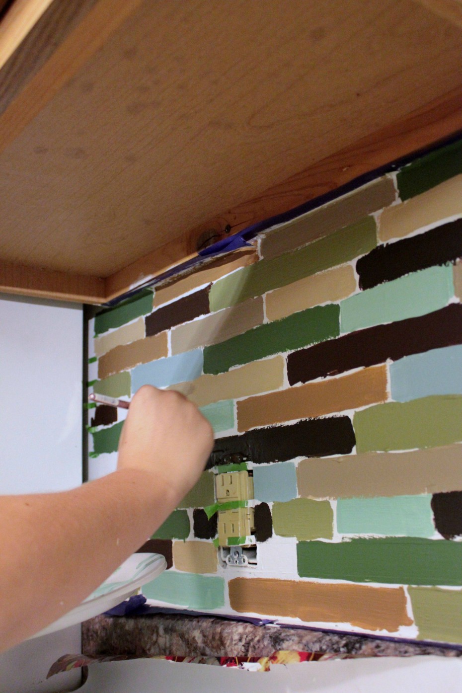 painting the tile for diy backsplash project