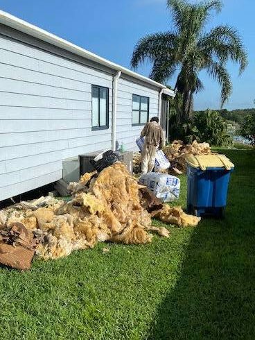 Step Removing Old Insulation Under A Mobile Home