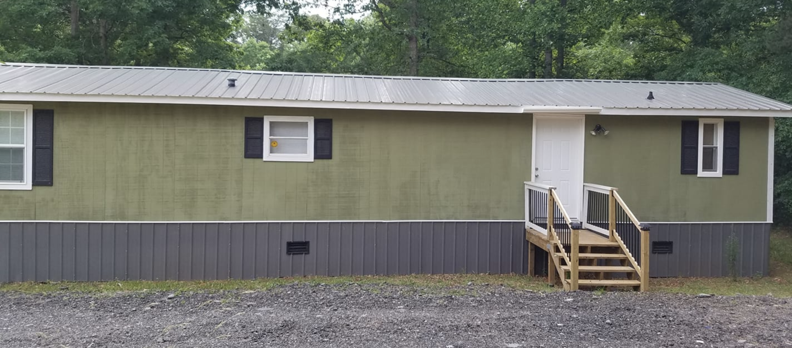 T11 Siding painted green on single wide mobile home