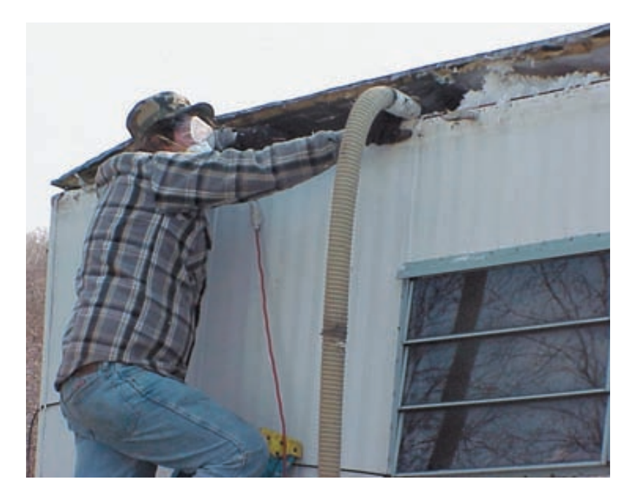 blowing-new-insulation-into-mobile-home-attic-space-HUD