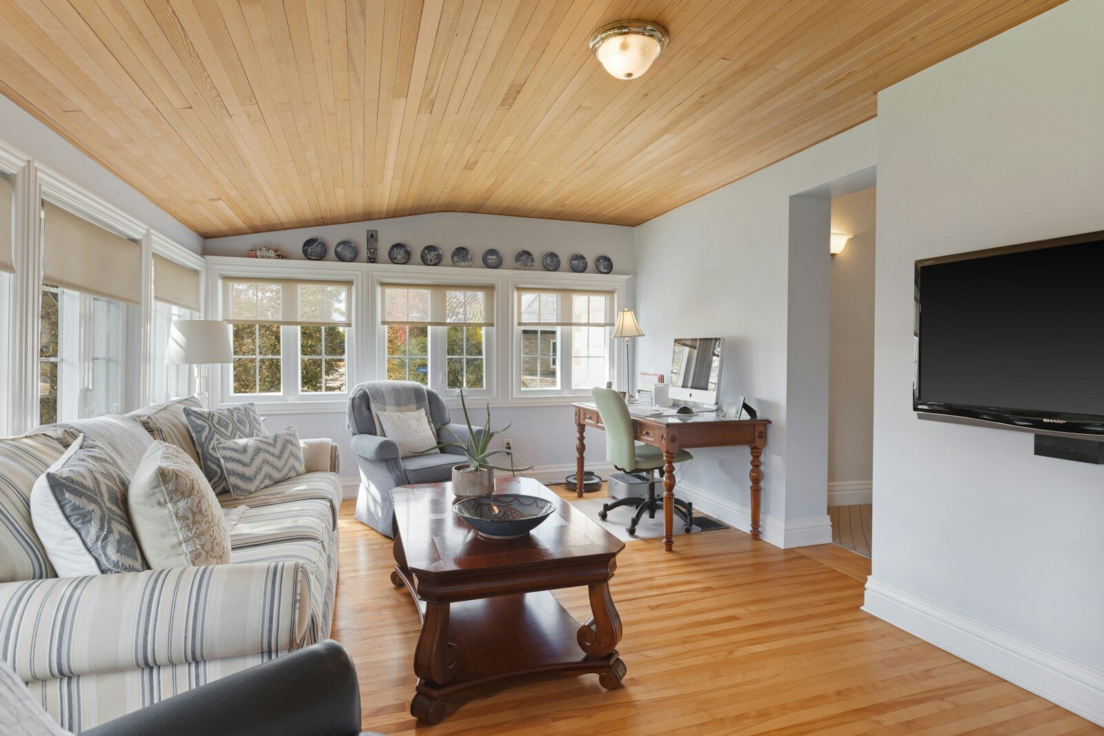 a living room filled with furniture and a flat screen tv