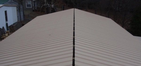 metal place over self-supporting mobile home roof over