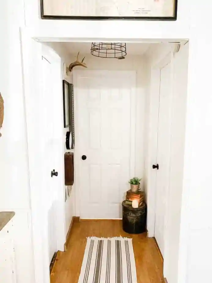 mobile home hallway with metal baskey light fixture - farmhouse style