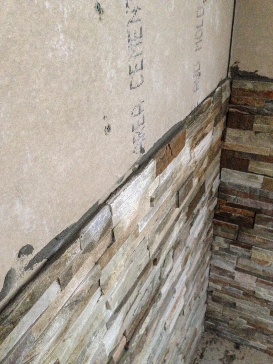 Stone tile behind wood stove installation